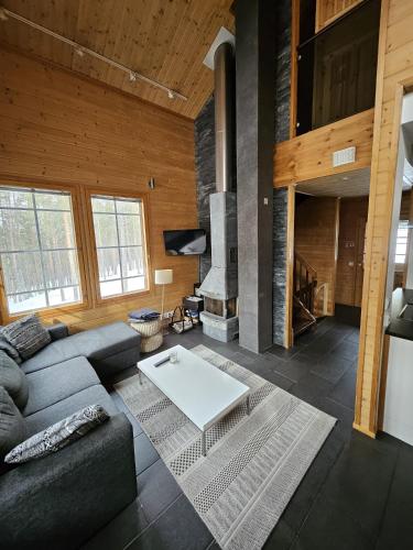 a living room with a couch and a table at Levi Happi in Kittilä