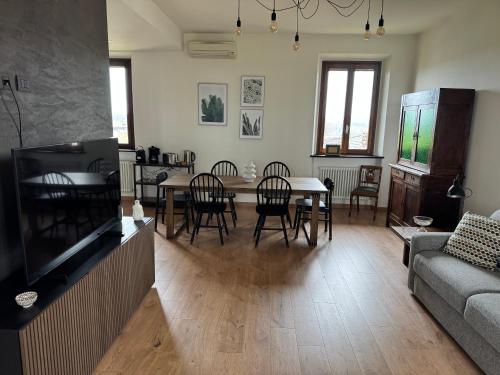 a living room with a couch and a table and chairs at Casa Gioja in Vizzola Ticino