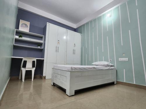 a bedroom with a bed and a desk and a chair at Akshay BnB & HomeStay in Lucknow