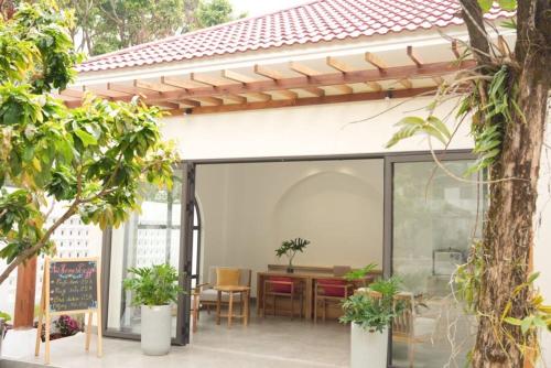 an open patio with a table and chairs at An Home - Garden Homestay in Plei Brel (2)