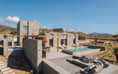 a villa with a swimming pool in the desert at Theros Villas Naxos in Plaka