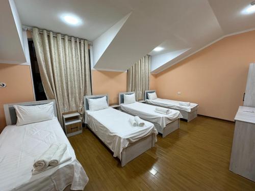 a hospital room with three beds in it at Sultan hotel boutique in Andizhan