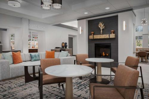 a lobby with couches and tables and a fireplace at Homewood Suites by Hilton Cleveland-Solon in Solon