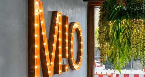 a large sign that says love hanging on a wall at PLAZA INN Blankenburg Ditzingen, Sure Hotel Collection in Ditzingen