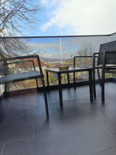a table and two chairs sitting on a balcony at Arinis Class in Gura Humorului
