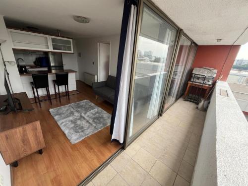 a living room with a view of a kitchen and a living room at Acogedor Depto Cercano al Metro in Santiago