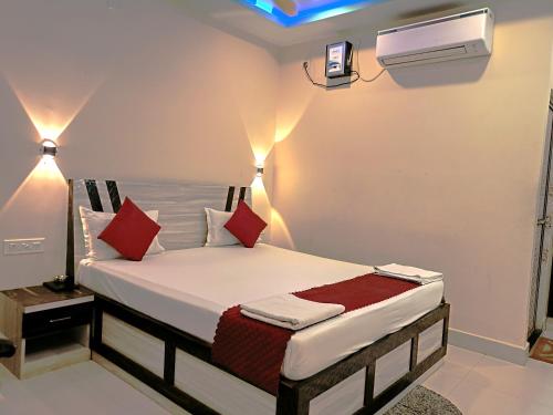 a bedroom with a bed with red pillows at Sea Wander Beach Resort in Mandarmoni