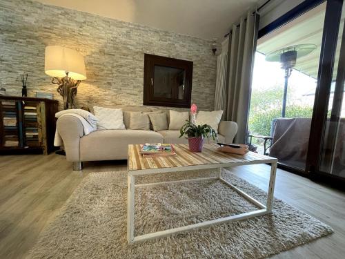 a living room with a couch and a coffee table at Casa Miralago - Cuasso al Monte in Cuasso Al Monte