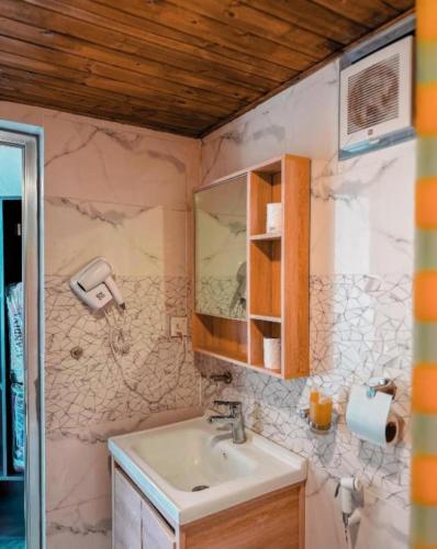 a bathroom with a sink and a mirror at Msek wadi rum camp in Disah