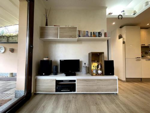 a living room with a entertainment center with a television at Casa Miralago - Cuasso al Monte in Cuasso Al Monte