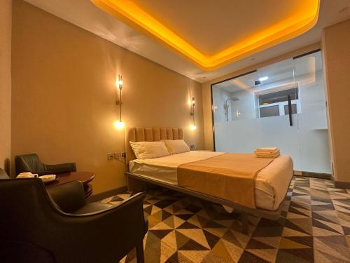 a hotel room with a bed and two chairs at Amure hotel in Ulaanbaatar