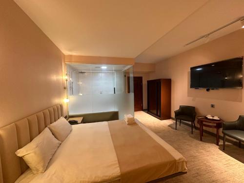 a hotel room with a bed and a television at Amure hotel in Ulaanbaatar