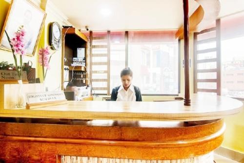 a man sitting at a counter in a restaurant at Hotel Khasi Heritage in Shillong