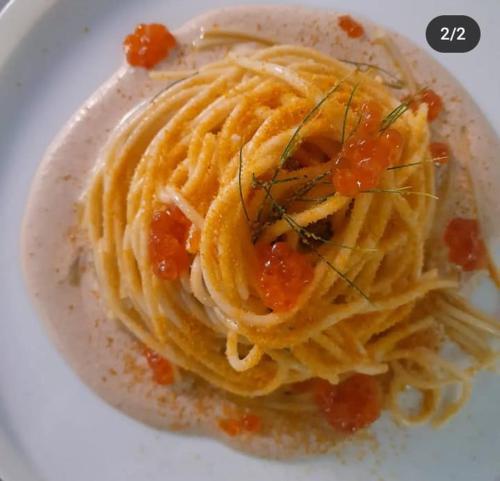a plate of pasta with sauce on a white plate at Locanda dei pescatori in Domaso