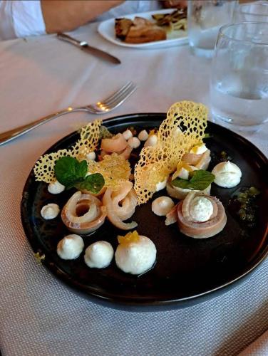 a plate of food with mushrooms on a table at Locanda dei pescatori in Domaso