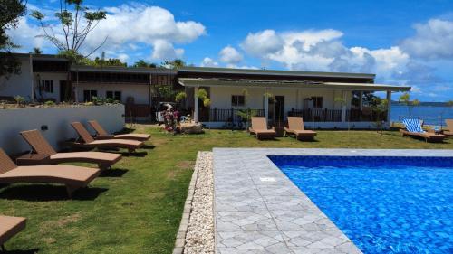 a house with a swimming pool next to a house at Seabreeze Haven Resort in Maria