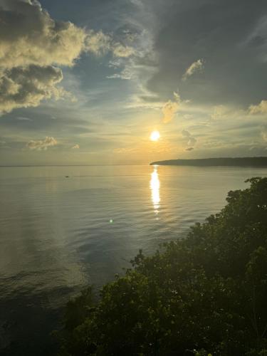 a sun setting over a body of water at Seabreeze Haven Resort in Maria