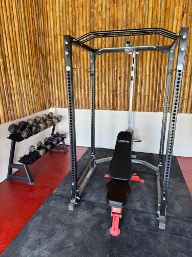 a gym with a bench and weights in a room at Seabreeze Haven Resort in Maria