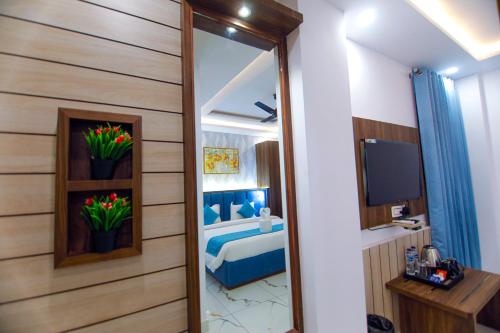 a room with a bedroom with a bed and a mirror at Paarth Grand in Haridwār