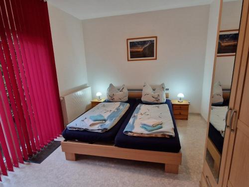 Ένα ή περισσότερα κρεβάτια σε δωμάτιο στο Carolas Ferienwohnungen im Ostseebad Heringsdorf