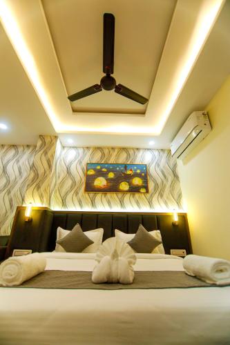 a bedroom with a large bed with a ceiling at Paarth Grand in Haridwār