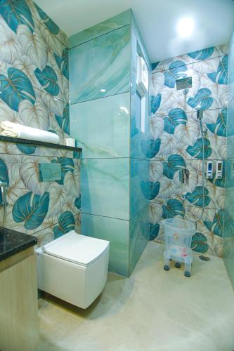 a bathroom with a shower and a toilet in it at Paarth Grand in Haridwār