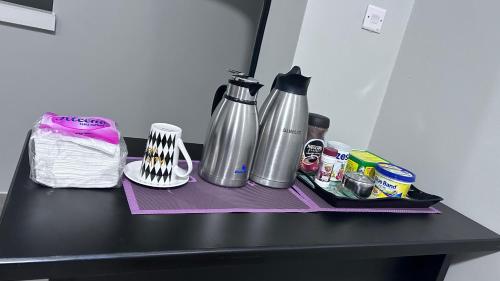 a black table with a counter top with a bottle of water at ViRRA Suites in Mbarara