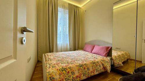 a small bedroom with a bed and a window at 2 Bedrooms Top Central Apartment on Vitosha Boulevard in Sofia