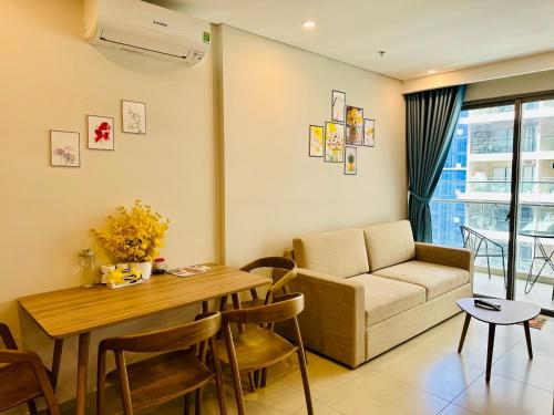 a living room with a couch and a table at Sóng Homestay-The Sóng Apartment Vũng Tàu Nghỉ Dưỡng Biển Cao Cấp 5 Sao- The Song Vung Tau Condotel 5 Star Beach View Apartment in Vung Tau