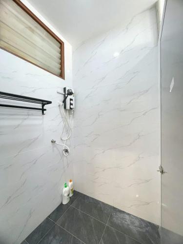 a bathroom with a shower and a phone on the wall at Vintage CoLiving 2Storey Haus in Bukit Mertajam