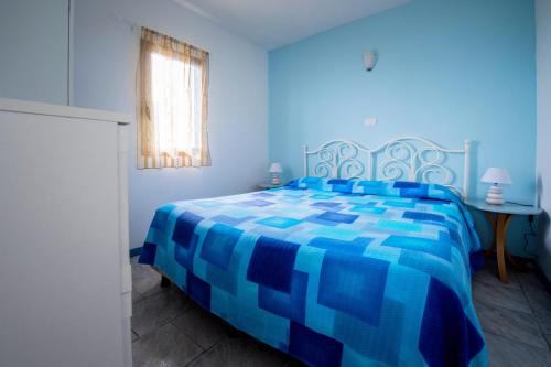 Кровать или кровати в номере Villaggio Residence Nettuno