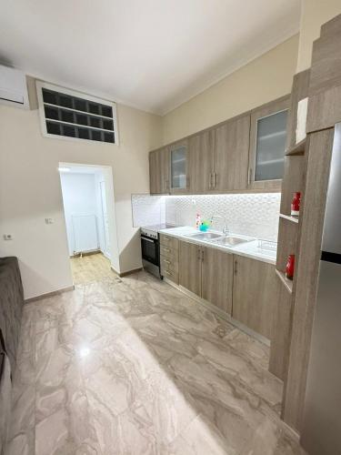 a large kitchen with a sink and a counter at Efesou Large Apartment in Néa Éfesos