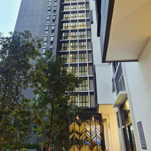 a tall building in the middle of a city at Alinea Suites Shah Alam in Shah Alam