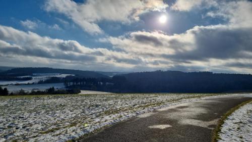 a road in the middle of a snow covered field at Auszeit in der Vulkaneifel in Üdersdorf