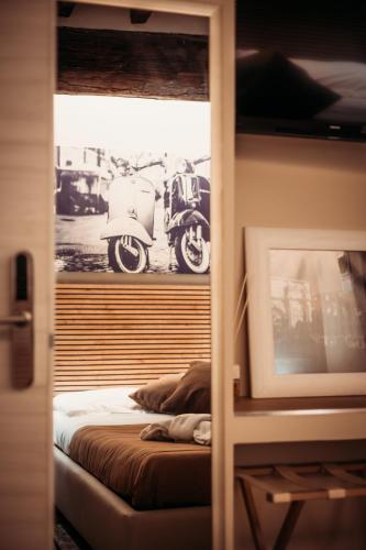 a bedroom with a bed with a motorcycle in a window at Hotel Domus Tiberina in Rome