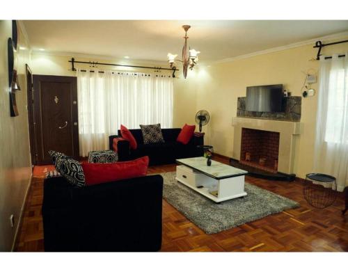 a living room with a couch and a coffee table at Spacious Town House in Nakuru in Nakuru