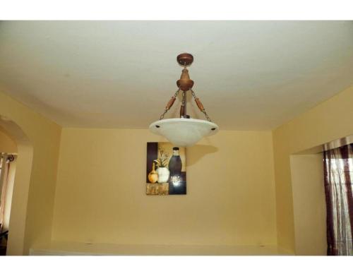 a chandelier hanging from a ceiling in a room at Spacious Town House in Nakuru in Nakuru