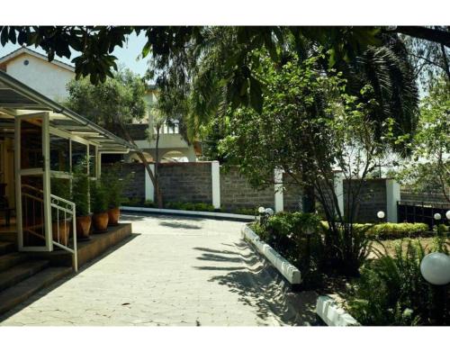a courtyard of a house with trees and plants at Spacious Town House in Nakuru in Nakuru