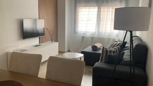 a living room with a couch and a tv at Apartamento Bellarhouse I in Ciudad Real