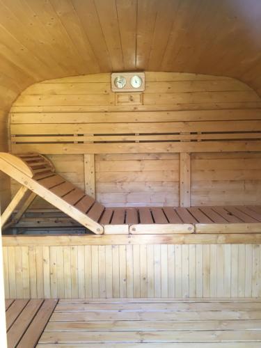 an inside of a sauna with a bed at Villa des glycines et Spa in Cempuis