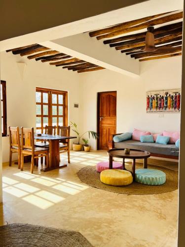 a living room with a couch and a table at Nyota ya Amani, Shela Lamu in Shela