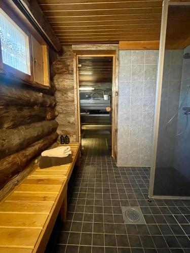 a bathroom with a walk in shower next to a toilet at Villa Havu in Kuusamo