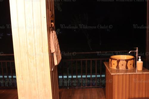 an open door of a porch with a tub at Woodlands Wilderness Chalet in Mādāri Hāt