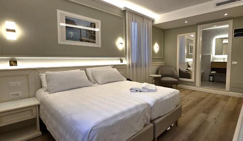 a bedroom with a large white bed in a room at Hotel Guerrini in Venice