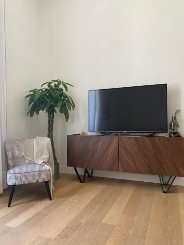 a living room with a flat screen tv on a entertainment center at NONSOLOMARE wifi aria condizionata Parcheggio in Sanremo