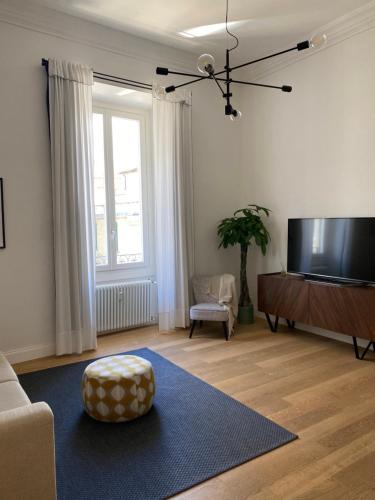 a living room with a flat screen tv and a couch at NONSOLOMARE wifi aria condizionata Parcheggio in Sanremo