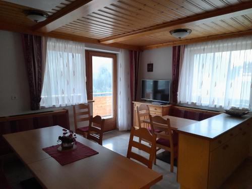 a living room with a table and a television at Haus Ladner - Josef und Marianne in Kappl