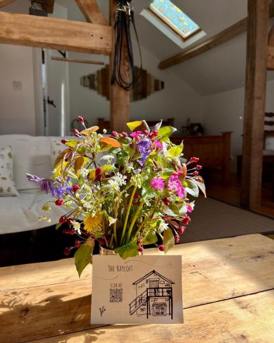 a bouquet of flowers sitting on top of a table at The Hayloft in Hereford