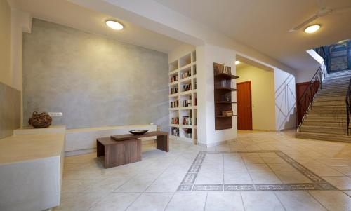 a room with a staircase and a bench and a table at Studios Marios in Kamari