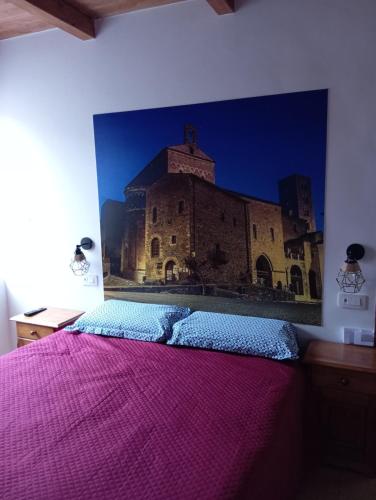 a bedroom with a large painting of a building at Vicolo della Quiete Anagni in Anagni